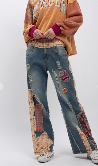 Distressed patchwork stretch denim pants with elastic waistband, loose fit, full-length silhouette and five pocket style