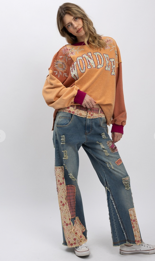 Distressed patchwork stretch denim pants with elastic waistband, loose fit, full-length silhouette and five pocket style