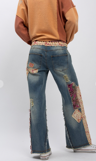Distressed patchwork stretch denim pants with elastic waistband, loose fit, full-length silhouette and five pocket style