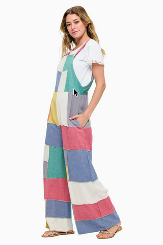Vibrant patchwork cotton overalls featuring a mix of colorful prints and textures, relaxed fit with adjustable straps, front bib pocket, and wide leg silhouette for a playful boho look