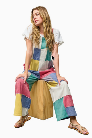 Vibrant patchwork cotton overalls featuring a mix of colorful prints and textures, relaxed fit with adjustable straps, front bib pocket, and wide leg silhouette for a playful boho look
