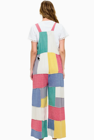 Vibrant patchwork cotton overalls featuring a mix of colorful prints and textures, relaxed fit with adjustable straps, front bib pocket, and wide leg silhouette for a playful boho look