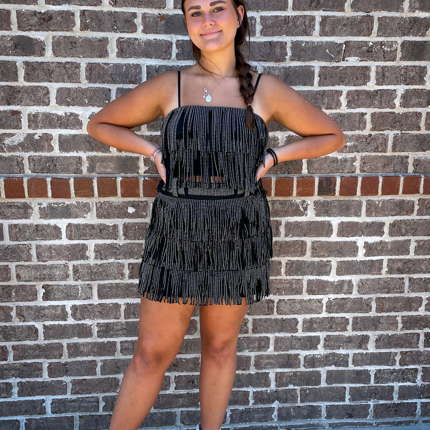 A breezy and blingy spaghetti strap crop top that comes in 4 colors, and matches our Rhinestone Diva Fringe Skirts for a complete look! 