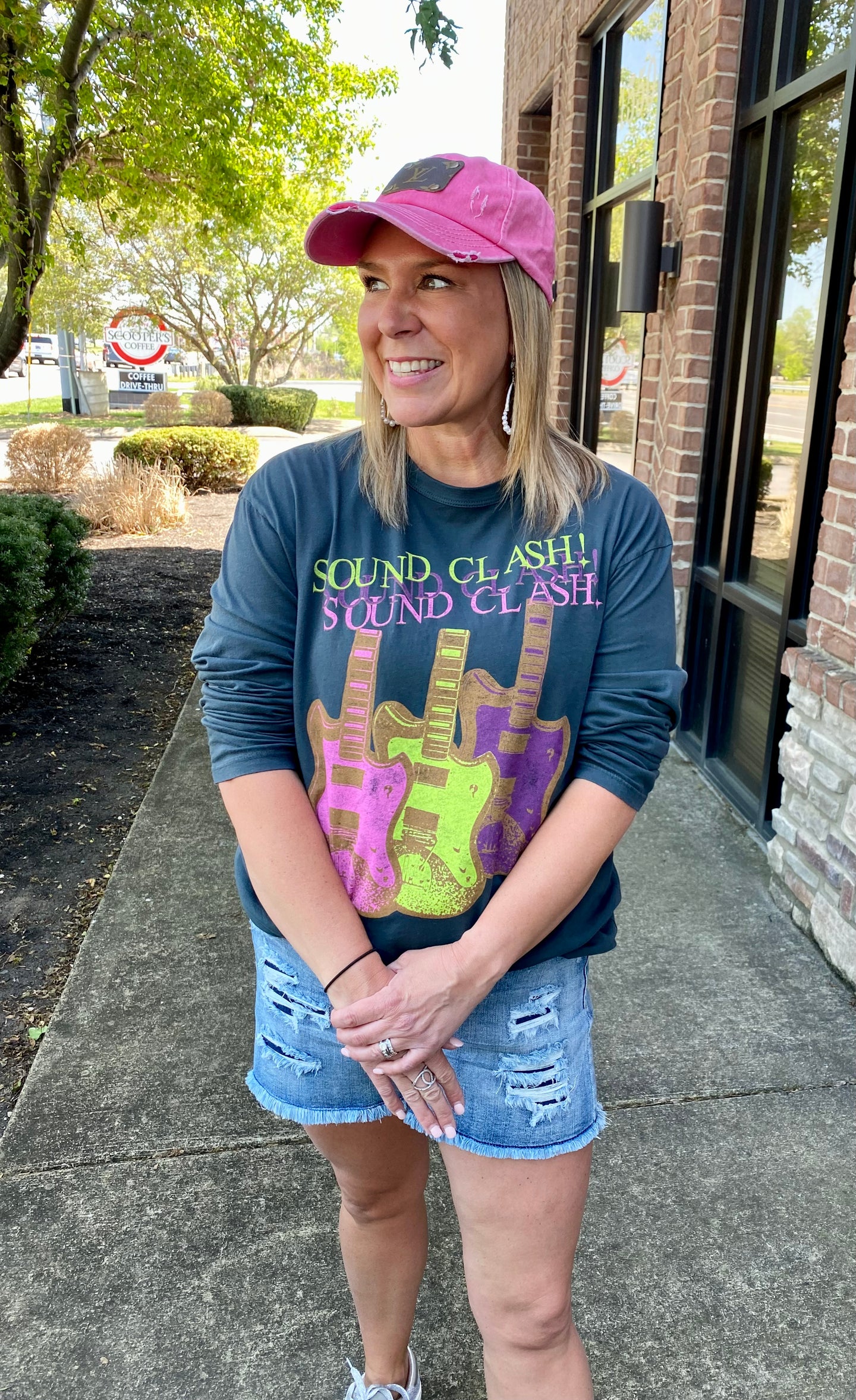 Rock On!! Everyone needs a good graphic tee in their closet. The Sound Clash Guitars Crew licensed graphic tee is long sleeve, perfect to throw on on those cooler days. It is a light charcoal gray color with fun pops of neon pink, green and purple. They are so easily paired with anything and spices your outfit up a little bit more. Great for concerts with flared jeans, a lazy day at home, or throw it on when your running errands. Effortlessly super cute!! We do think that this tee runs true to size.