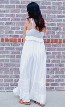 The Coastal Cowgirl ruffle detail Maxi dress features a v neck design with strappy shoulder ties. There is a complimenting ruffled detail along the bust line and the dress is a flattering a line tiered dress. The back features a soft ruched design making the dress comfortable and flattering for all who wear it. It is lined with a knee length slip underneath. Pair with your favorite cowgirl boots and a hat or wedges to look adorable for any event. 